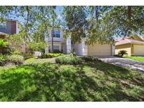 Charming two-story home with well-maintained landscaping and a spacious two-car garage at 1936 Westpointe Cir, Orlando, FL 32835