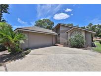 Charming home featuring a two-car garage, a well-manicured lawn, and a welcoming front entrance at 247 W Sabal Palm Pl, Longwood, FL 32779