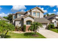 Charming two-story home with a well-maintained lawn and beautiful landscaping, creating great curb appeal at 2638 Clarinet Dr, Orlando, FL 32837