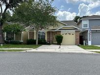 Charming single-Gathering home with a well-manicured lawn and attached two car garage at 3352 Hamlet Loop, Winter Park, FL 32792