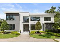 Modern two-story home showcasing clean lines, large windows, and professionally landscaped front yard at 350 Northwind Rd, Maitland, FL 32751