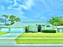 Charming single-story home featuring manicured lawn and a two-car garage at 3708 Beaver Ridge Dr, Orlando, FL 32829