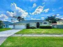 Charming single-story home features a well-manicured lawn and a two-car garage at 3708 Beaver Ridge Dr, Orlando, FL 32829