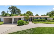Charming single-story home with manicured landscaping, a carport, and a welcoming front entrance at 3722 Neptune Dr, Orlando, FL 32804