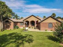 Charming single-story home featuring brick accents, manicured lawn, and inviting curb appeal on a sunny day at 448 Warrior Trl, Deltona, FL 32725