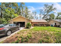 Charming single-story home with a stone facade and well-maintained front yard at 4799 Lighthouse Rd, Orlando, FL 32808