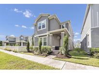 Beautiful two-story home with manicured lawn, inviting porch, and gray painted exterior at 640 Bayern Ln, Debary, FL 32713