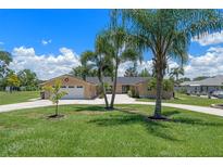 Charming home with a spacious front yard, long driveway, and lush green lawn at 6790 Bay Shore Dr, St Cloud, FL 34771