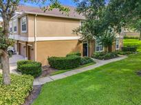Beautiful two-story townhome featuring a two-car garage, manicured landscaping, and a welcoming entryway at 725 Ashworth Overlook Dr # C, Apopka, FL 32712