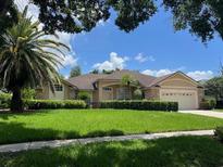 Inviting single-story home featuring a well-maintained lawn and mature landscaping at 8012 Old Town Dr, Orlando, FL 32819