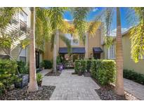 Charming townhouse with well-manicured landscaping, a private entrance, and a paved walkway at 901 E Pine St # 2, Orlando, FL 32801