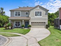 Charming two-story home with a well-manicured lawn, mature landscaping, and a welcoming front entrance at 9319 Marsh Oaks Ct, Orlando, FL 32832
