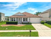 Charming single-story home with a well-manicured lawn, beautiful shrubbery and a two-car garage at 10151 Chorlton Cir, Orlando, FL 32832