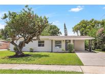 Charming single-story home featuring a well-maintained lawn and mature shade tree at 214 S Cottage Hill Rd, Orlando, FL 32805