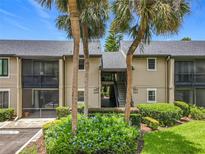 Inviting condo exterior featuring tropical landscaping and easy access to units, offering a serene atmosphere at 305 West Lake Faith Dr # 139, Maitland, FL 32751