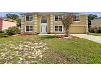 Two-story home featuring a manicured lawn and an attached two-car garage at 4209 Sw 33Rd St, Ocala, FL 34474