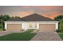 Beautiful home exterior with a two-car garage and well-manicured lawn, perfect for suburban living at 5174 Gardenrow Dr, St Cloud, FL 34772