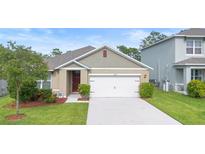 Charming single-story home featuring a well-maintained lawn and two-car garage at 522 Anne St, Deland, FL 32724
