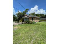 Charming single-story home with a well-manicured lawn and a classic white picket fence at 1307 Mabbette St, Kissimmee, FL 34741