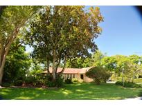 Charming one-story home nestled among mature trees and a well-maintained lawn at 1509 Huntington St, Deltona, FL 32725