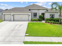 Charming single-story home with a well-manicured lawn and a spacious three-car garage at 1789 Chatsworth Cir, St Cloud, FL 34771