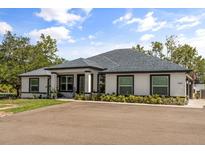 Charming single-story home boasting a manicured lawn, contrasting trim, and an inviting front entrance at 18826 Reynolds Pkwy, Orlando, FL 32833