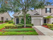Charming townhome features a well-manicured lawn and an attached one-car garage at 2092 Switch Grass Cir, Ocoee, FL 34761