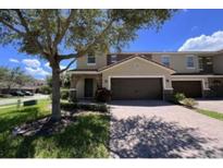 Inviting townhouse with a two-car garage and meticulously maintained landscaping at 2183 Leather Fern Dr, Ocoee, FL 34761