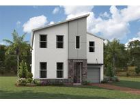 Modern two-story home boasts neutral colors, a stone entryway, a one car garage, and beautiful landscaping at 2325 Salty Winds Way, Kissimmee, FL 34747