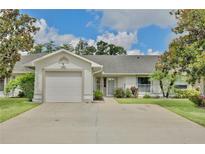 Charming single-story home with an attached garage and well-maintained landscaping at 3415 Celena Cir, St Cloud, FL 34769