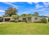 Charming home with well-maintained lawn, lush landscaping, and light blue trim at 426 Illinois Ave, St Cloud, FL 34769