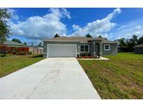 Charming single-story home with a two-car garage and well-maintained landscaping at 4437 Sw 159Th Pl, Ocala, FL 34473