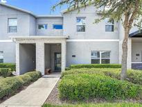 Contemporary townhome boasts a modern facade with manicured landscaping and a welcoming entrance at 850 Pebble Beach Dr, Davenport, FL 33896
