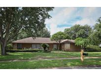 Charming single-story home with stone accents, mature trees, and well-maintained landscaping at 9206 Everwood St, Orlando, FL 32825