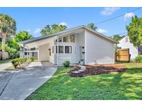 Charming single-story home with carport, landscaped yard, and contemporary design details at 1310 Oregon St, Orlando, FL 32803