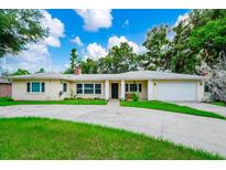 Charming single-story home featuring a well-manicured lawn and a two-car garage at 1420 Rock Lake Dr, Orlando, FL 32805