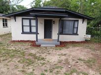 Charming bungalow-style home with a minimalist front porch and tidy landscaping at 2107 Hollywood Ave, Eustis, FL 32726