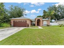 Charming single-story home featuring a well-maintained lawn and a two-car garage at 470 Cardinal Ct, Kissimmee, FL 34759
