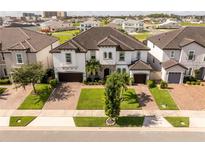 Stunning two-story home featuring a well manicured lawn, brick-paved driveway, and attached two car garage at 8066 Ludington Cir, Orlando, FL 32836