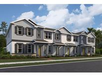 Charming two-story townhomes with neutral exteriors, welcoming front doors, and well-maintained landscaping at 1379 Mount Royal Dr, St Cloud, FL 34771