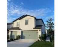 Charming two-story home featuring a well-maintained lawn and an attached two-car garage at 1635 Wynford Cir, Tavares, FL 32778