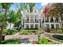 Charming townhouse featuring a beautiful exterior, lush landscaping, and a welcoming entrance at 2036 Brink Aly, Orlando, FL 32814