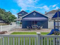 Charming backyard with a patio, artificial grass, and playful features, perfect for relaxation and outdoor enjoyment at 2604 Marble Ave, Orlando, FL 32803