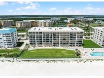 Aerial view showcases the waterfront condominium, pool, spa and tennis courts at 4631 S Atlantic Ave # 8102, Port Orange, FL 32127