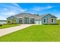 Beautiful home with a well-manicured lawn and a circular driveway at 5005 Shore Side Dr, Lakeland, FL 33812