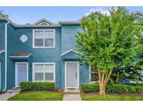 Charming two-story home with a well-manicured front lawn and blue exterior paint at 517 Wilton Cir, Sanford, FL 32773