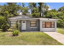 Charming single-story home with a well-maintained front yard and gray painted stucco at 600 Plum Ln, Altamonte Springs, FL 32701