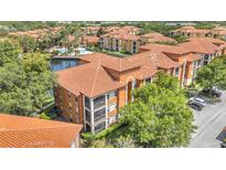 Beautiful waterfront condo featuring screened balconies and a classic tile roof at 6149 Metrowest Blvd # 103, Orlando, FL 32835