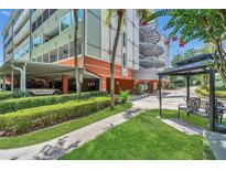 A stylish condo building with a well-manicured lawn and convenient covered parking at 690 Osceola Ave # 410, Winter Park, FL 32789