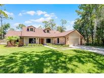 Charming single-story home with manicured lawn and inviting entrance, offering great curb appeal at 8665 Vista Point Cv, Orlando, FL 32836